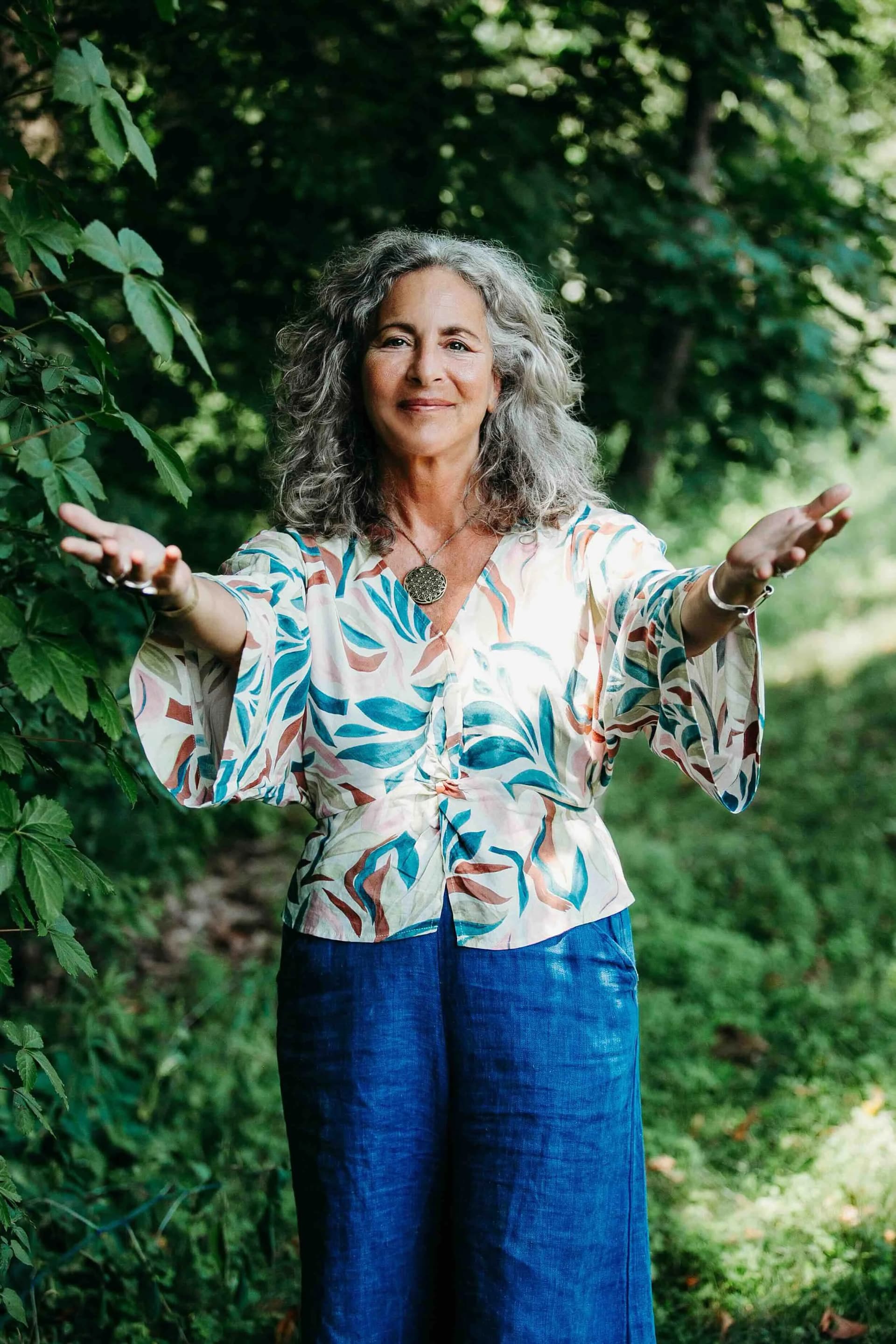 Heidi Feinstein, founder of Rooted Vision Studio, arms outstretched